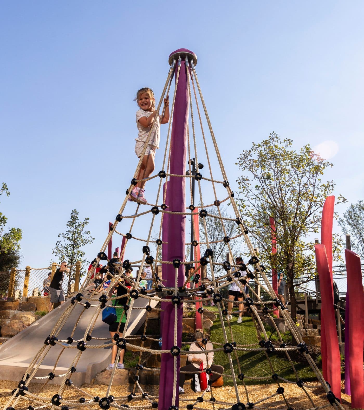 Child climbing the rope net tower in the Children’s Play Area